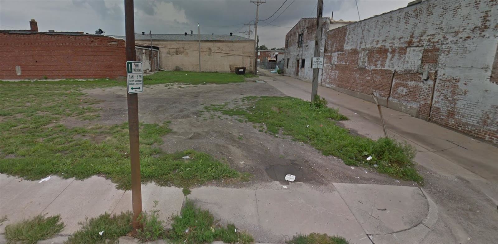 Empty plot of land surrounded by run down buildings